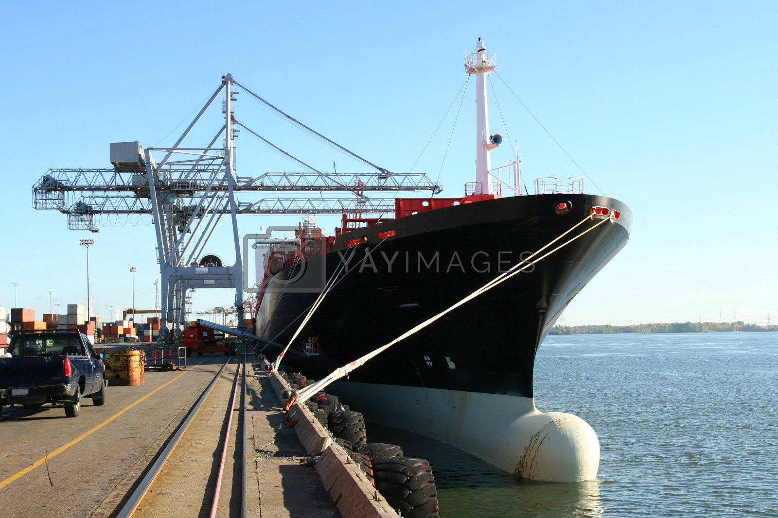Royalty free image of Container ship being loaded by le_cyclope
