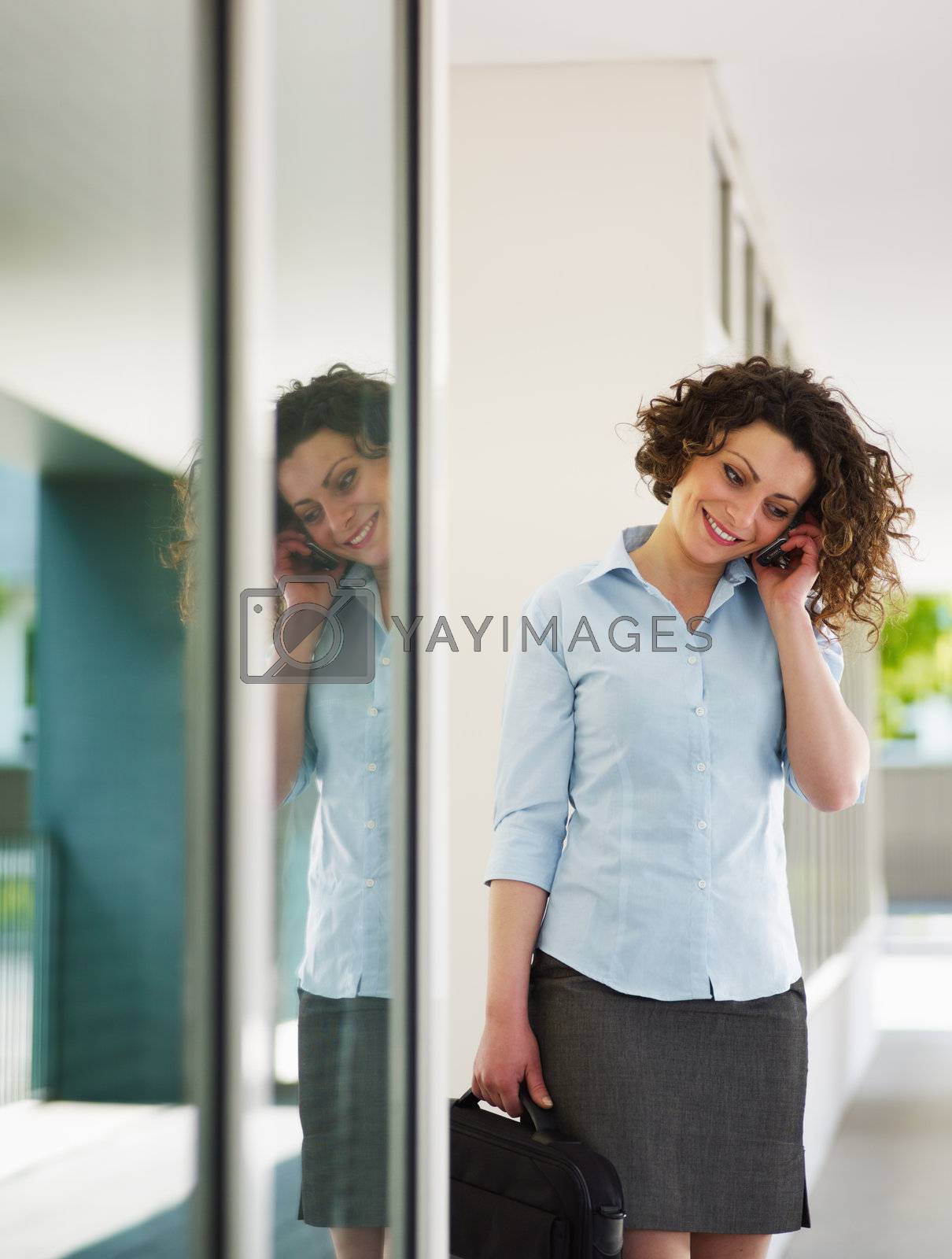 Royalty free image of mid adult businesswoman on the phone by diego_cervo
