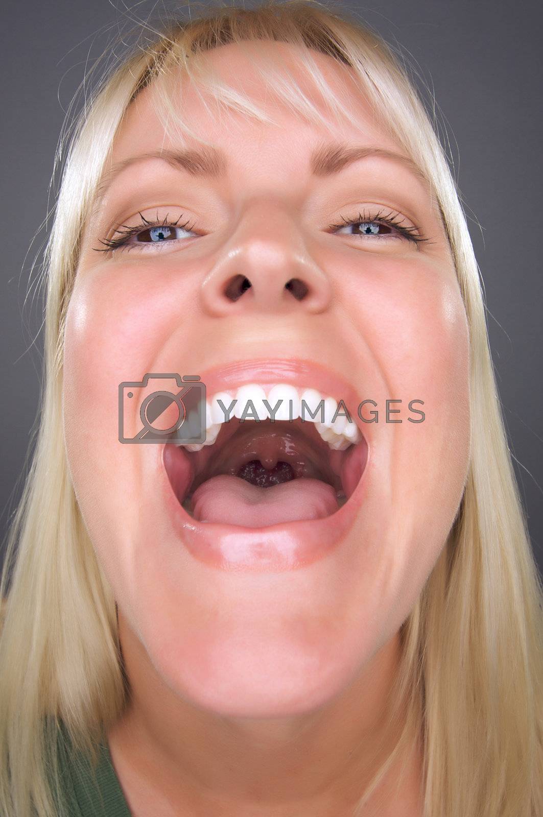 Royalty free image of Laughing Blond Woman with Funny Face by Feverpitched