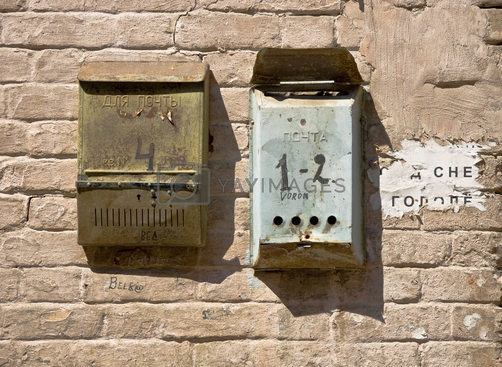 Royalty free image of brick wall with mailboxes by Oledjio