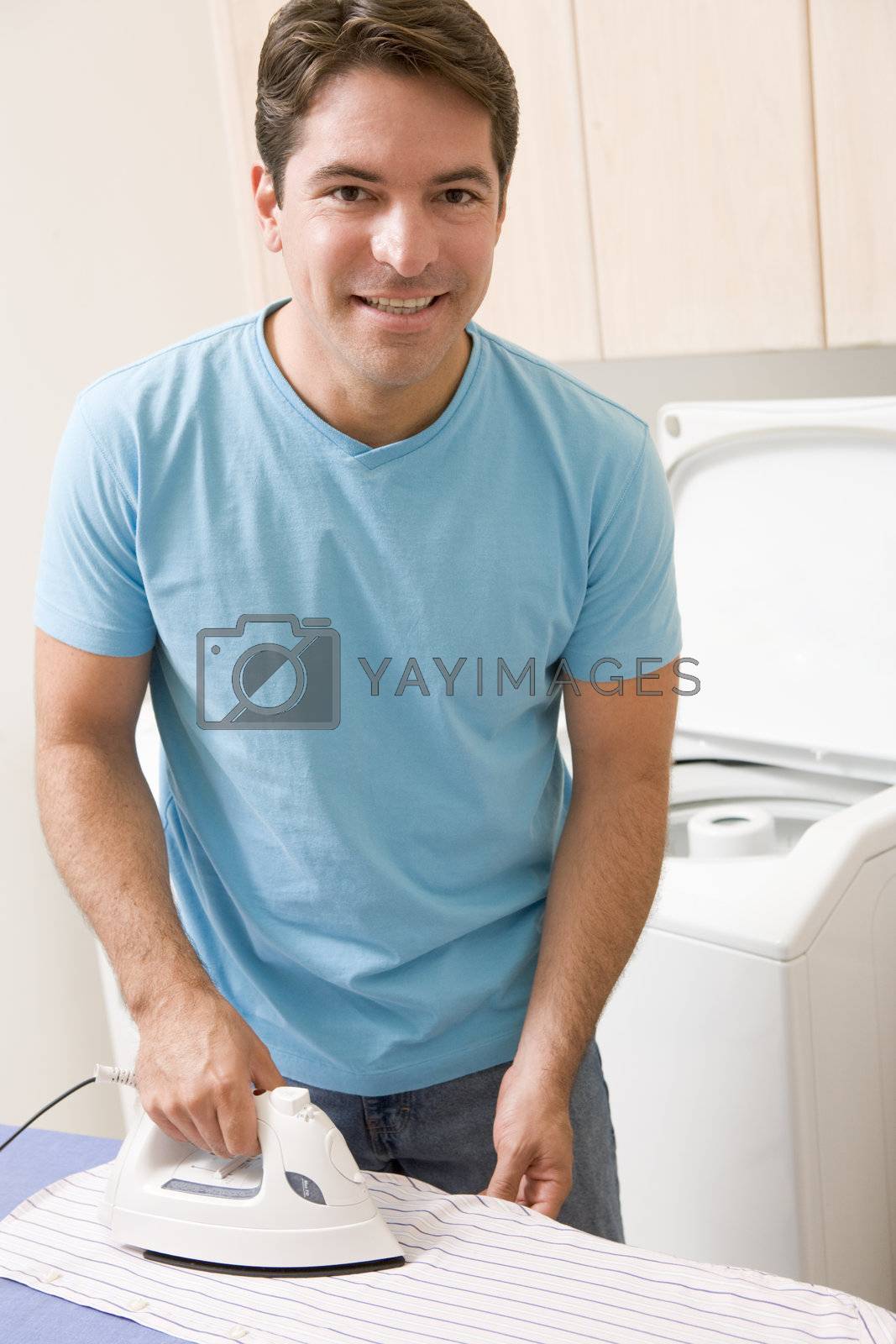 Royalty free image of Man Ironing Shirt by MonkeyBusiness