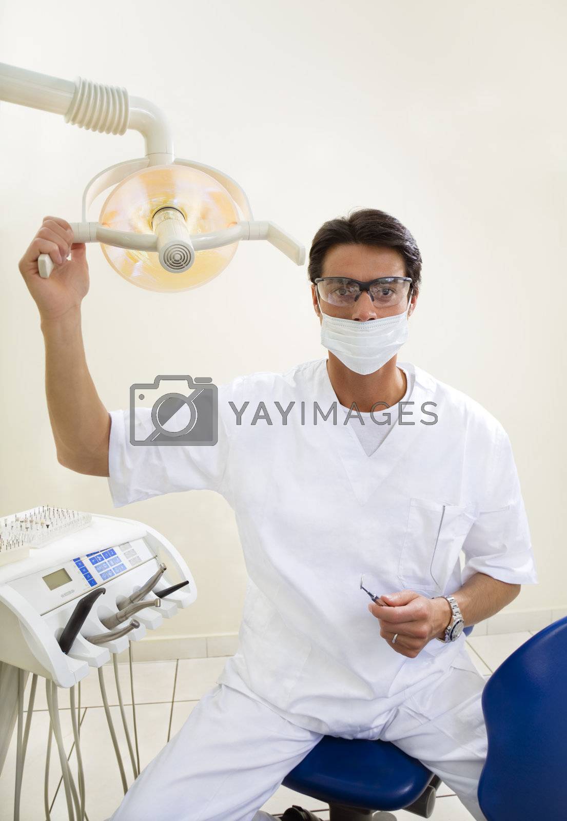 dentist turning on examination light