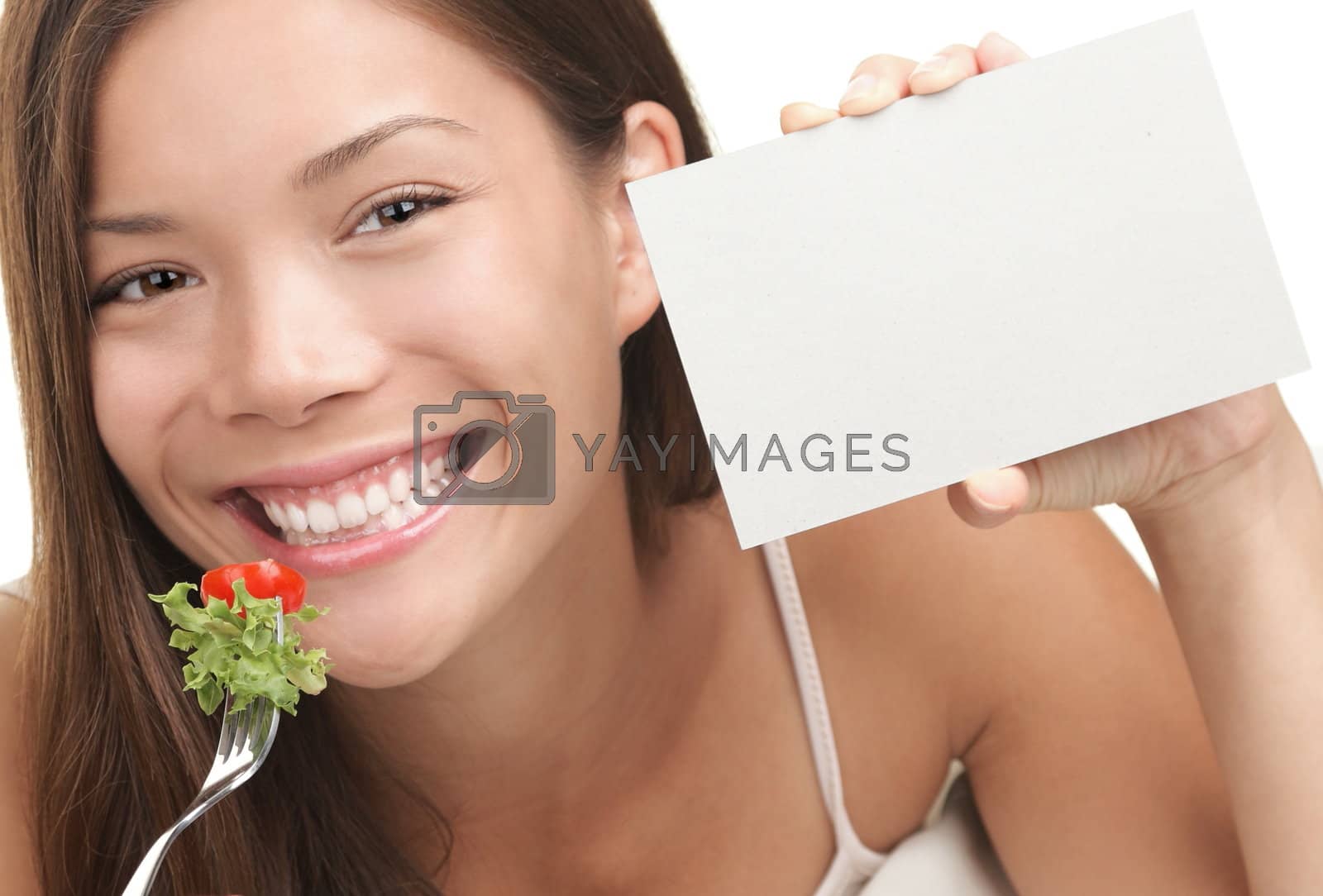 Royalty free image of Woman Eating Healthy Salad by Ariwasabi