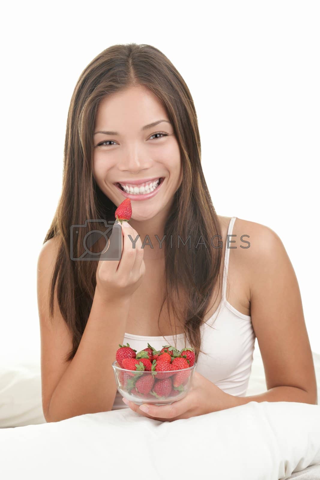 Royalty free image of Woman eating strawberries by Ariwasabi