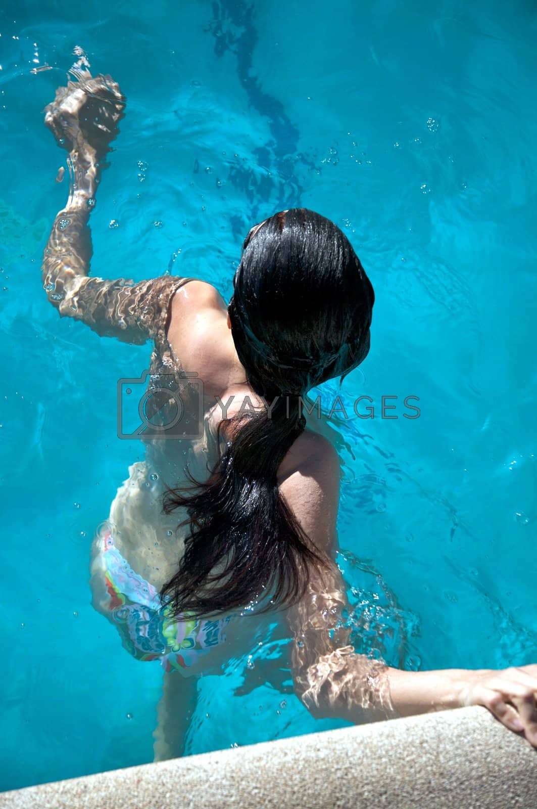 Royalty free image of woman waiting to swim by quintanilla