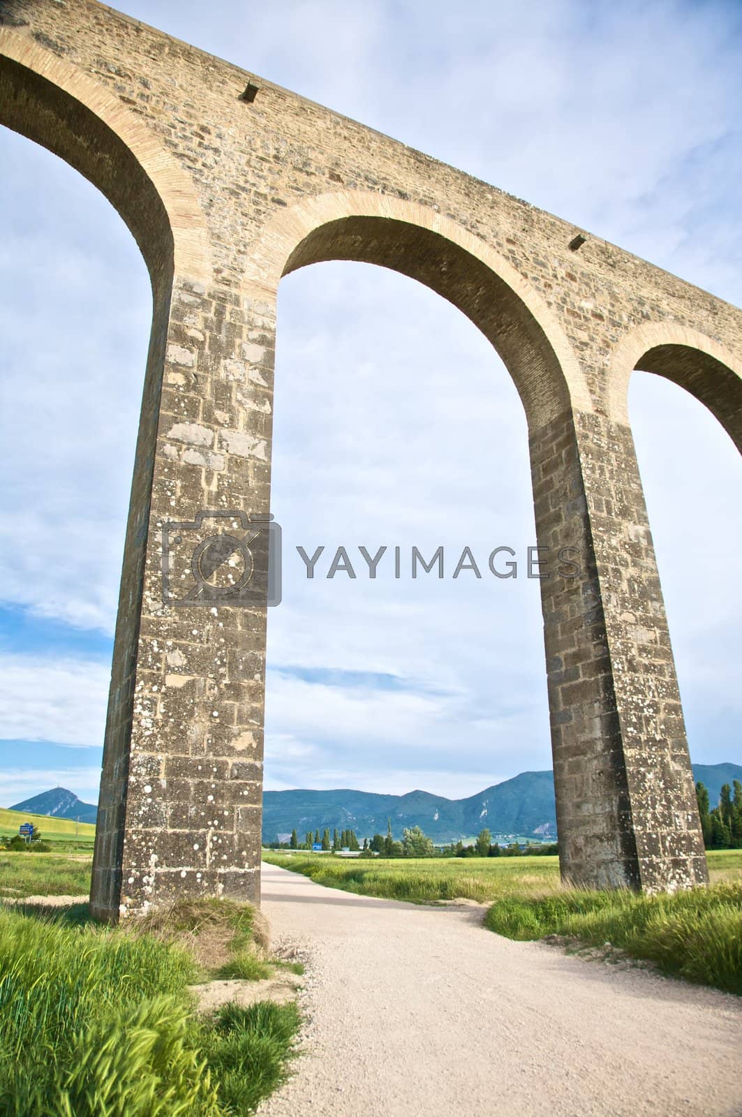 Royalty free image of great arch of aqueduct by quintanilla