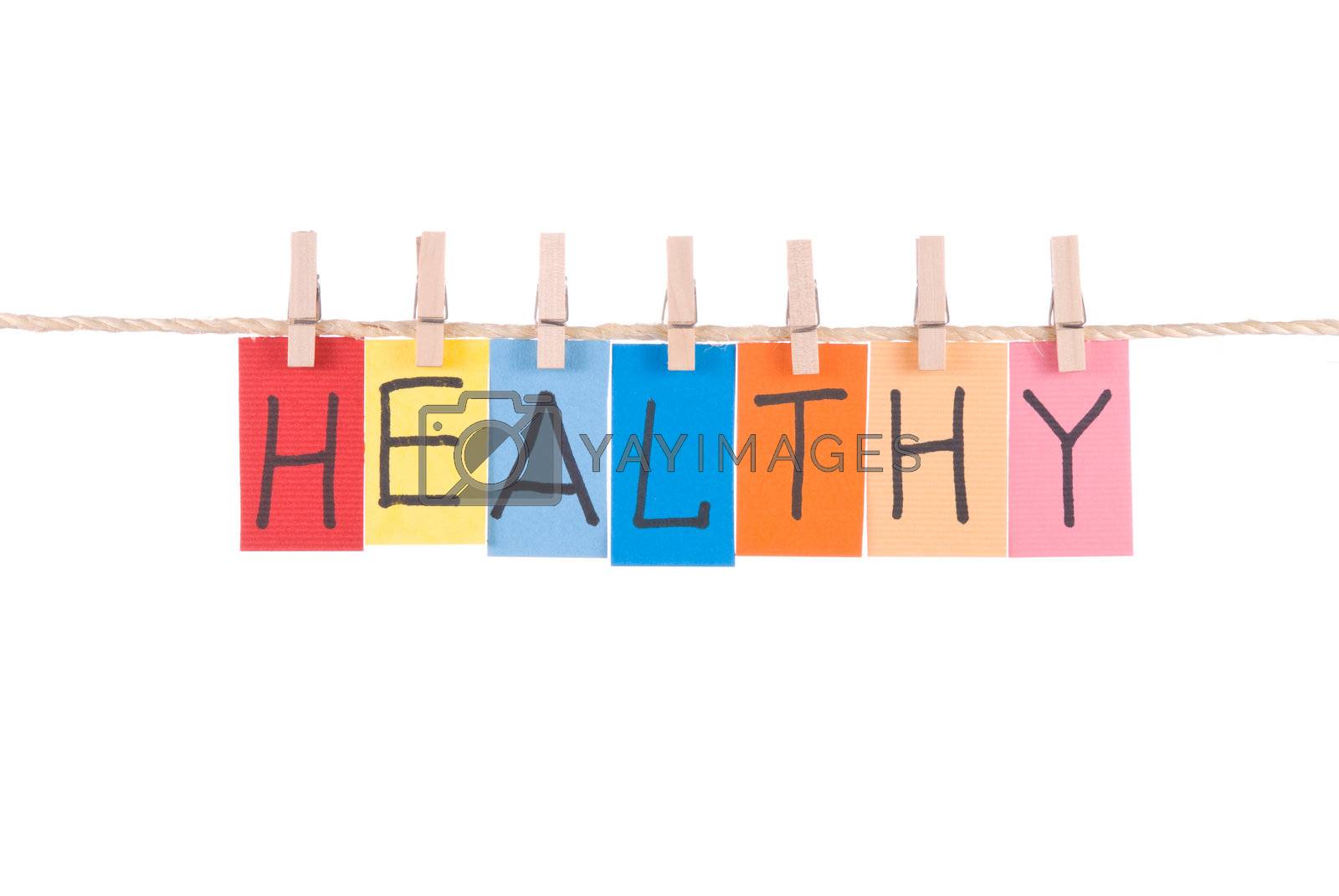 Royalty free image of Healthy, words hang by wooden peg  by Lawren