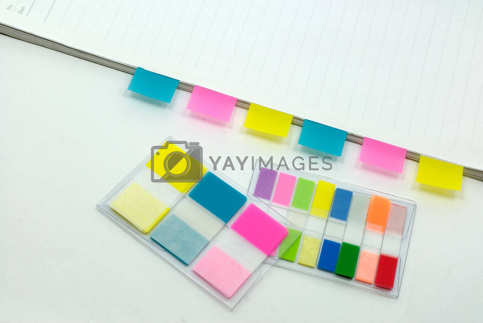 Royalty free image of tags on notebook with pen in white background by elwynn