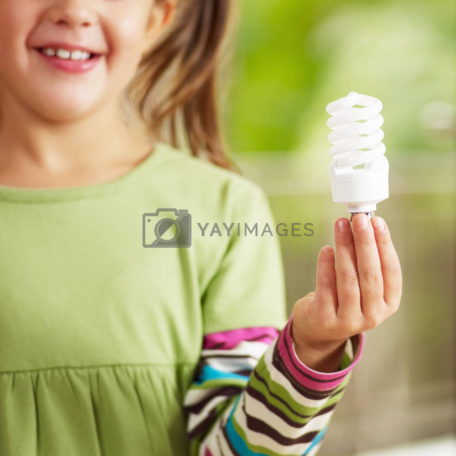 Royalty free image of Girl holding light bulb by diego_cervo