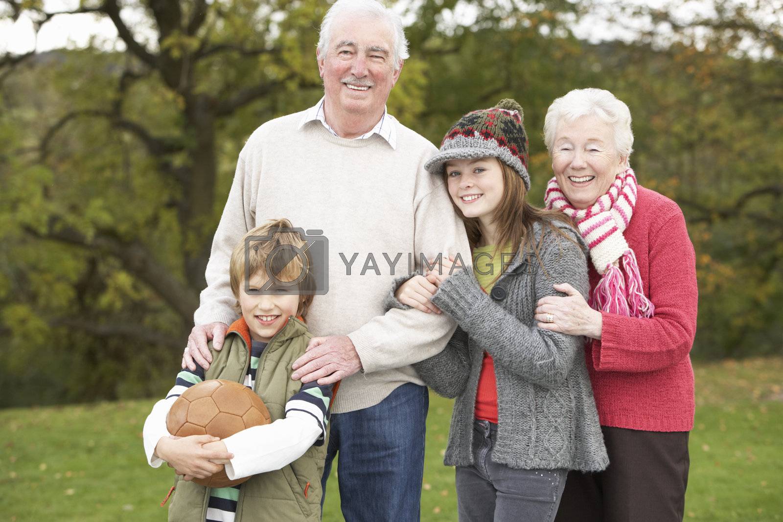 Royalty free image of Grandparents With Grandchildren Holding Football Outside by omg_images