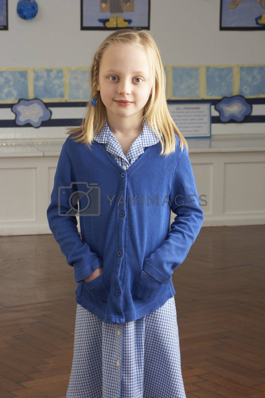 Royalty free image of Portrait Of Female Primary School Pupil Standing In Classroom by omg_images