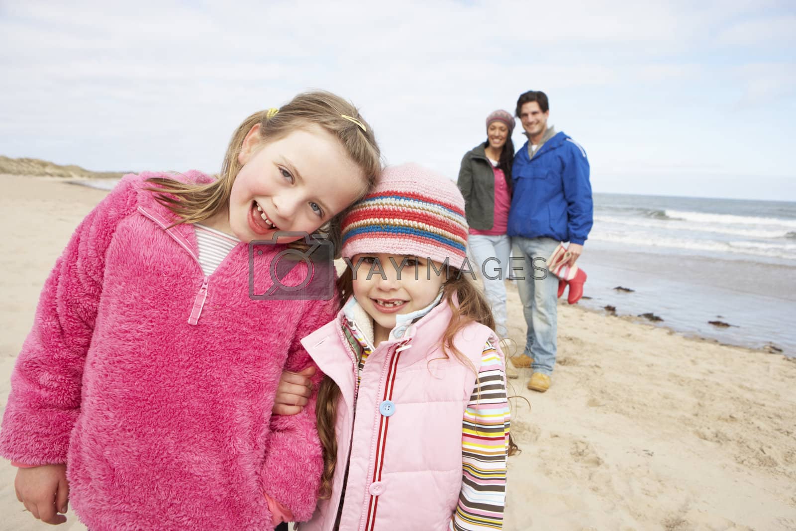 Royalty free image of Family Walking Along Winter Beach by omg_images