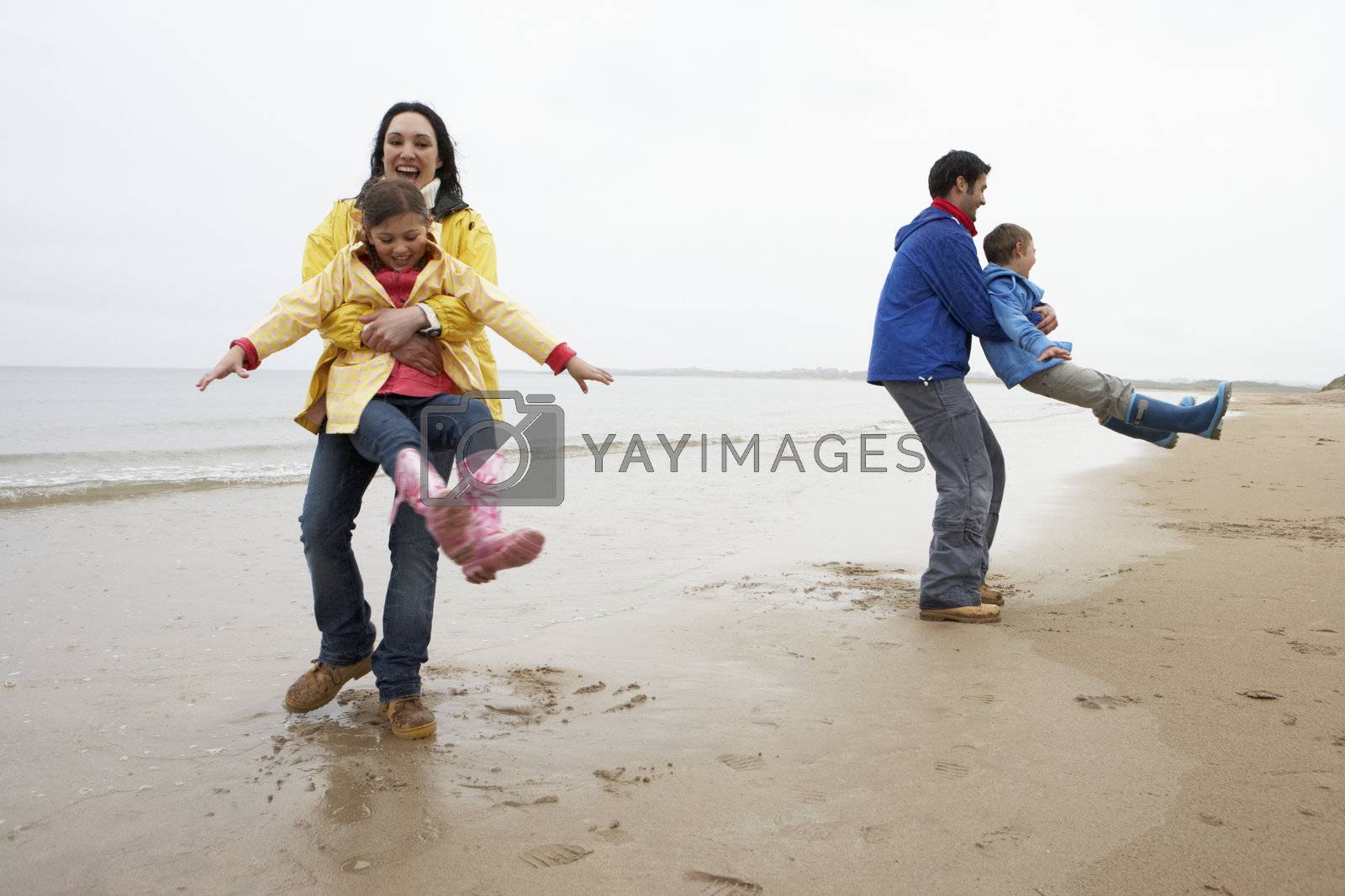 Royalty free image of Family playing on beach by omg_images