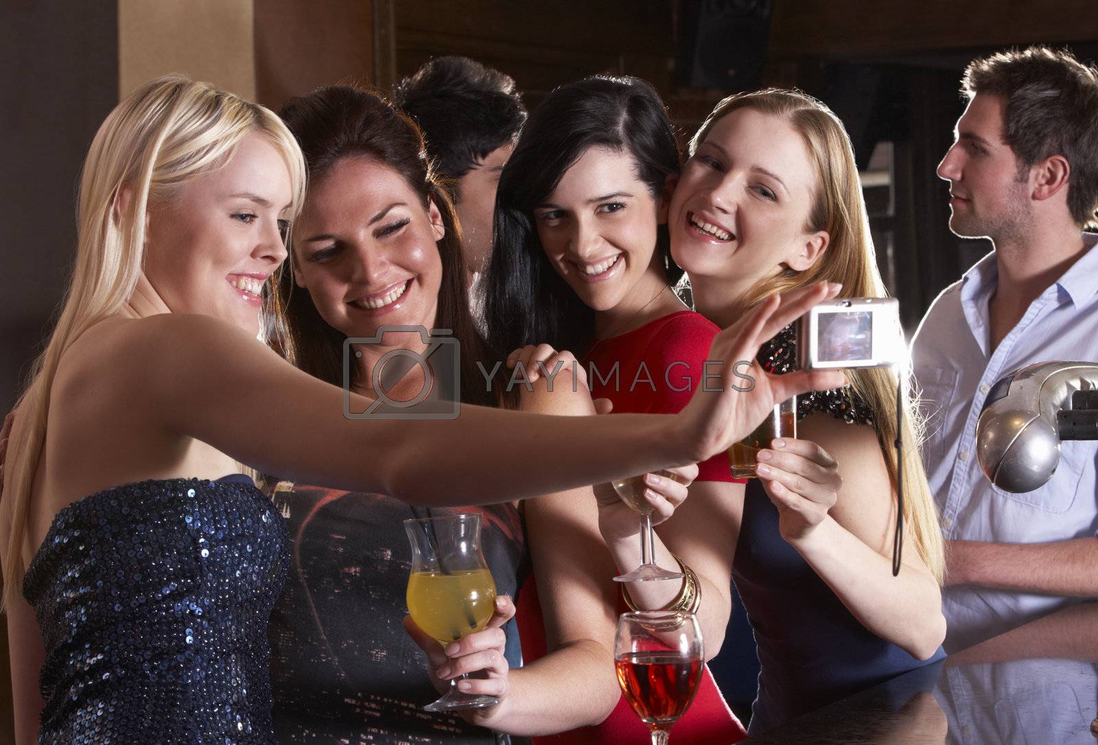 Royalty free image of Young women drinking at bar by omg_images