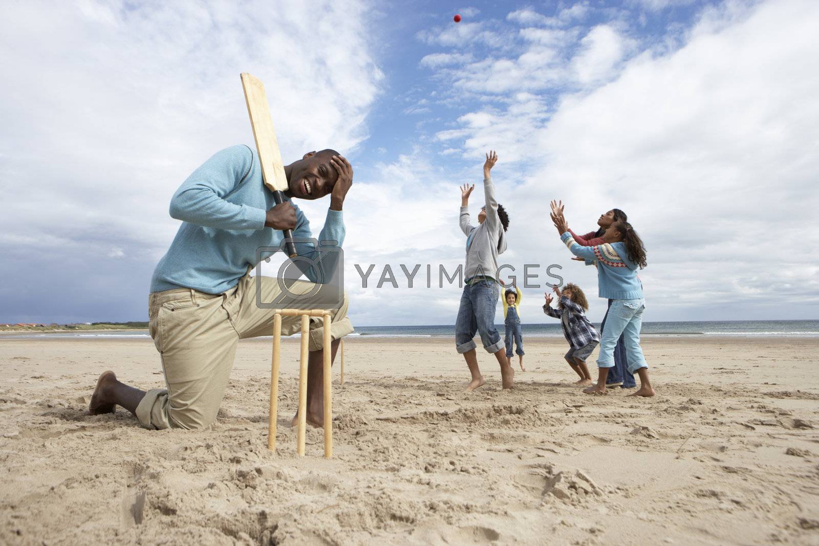 Royalty free image of Family playing cricket on beach by omg_images