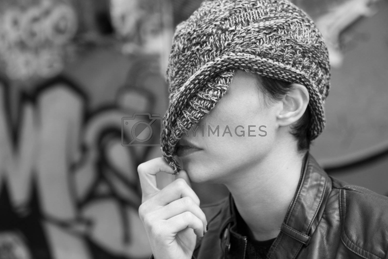 Royalty free image of Woman hiding behind her cap by allg