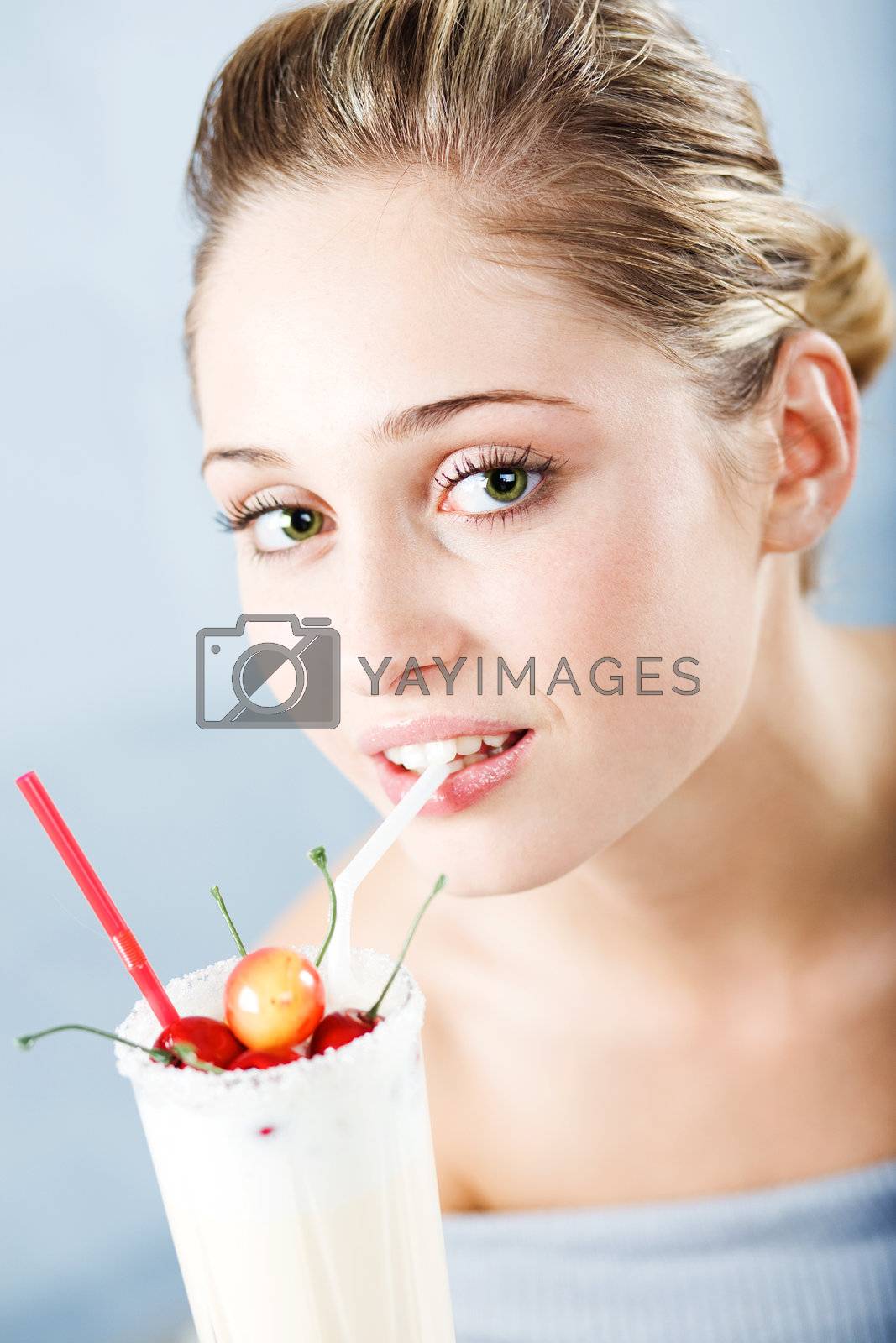 Royalty free image of Girl drinking milk cocktail by alenkasm