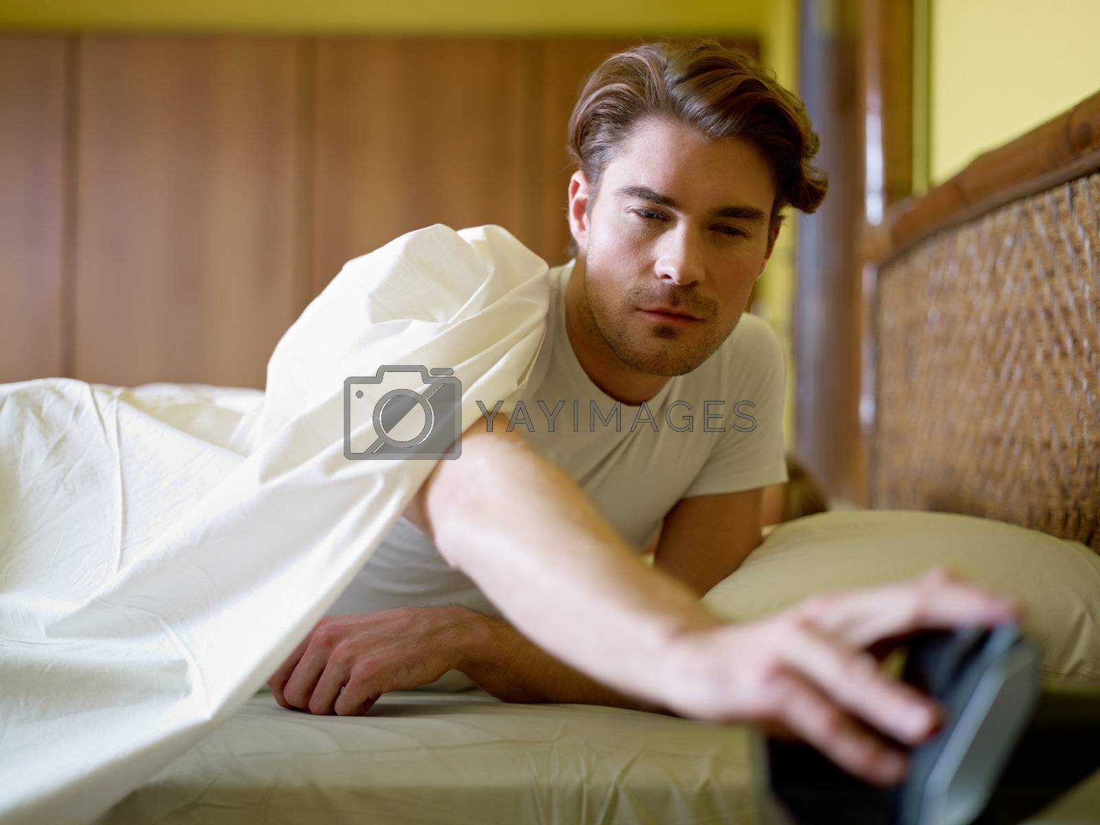 Royalty free image of young adult man waking up in the morning by diego_cervo