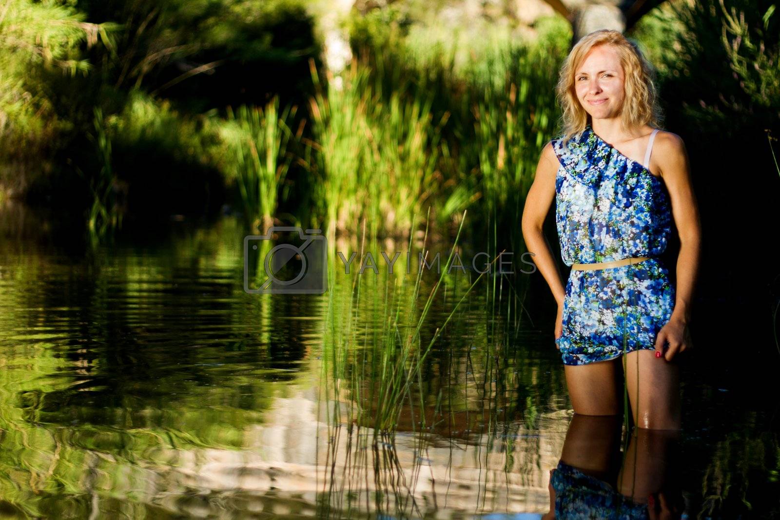 Royalty free image of beautiful young girl on the river by membio