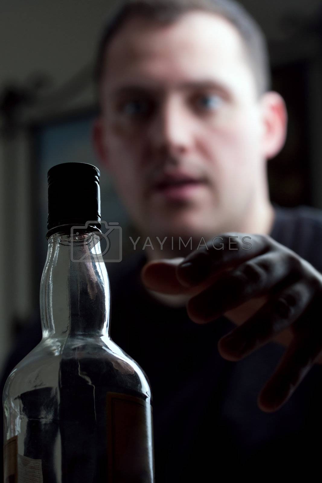 Royalty free image of Man Reaching For the Liquor Bottle by graficallyminded