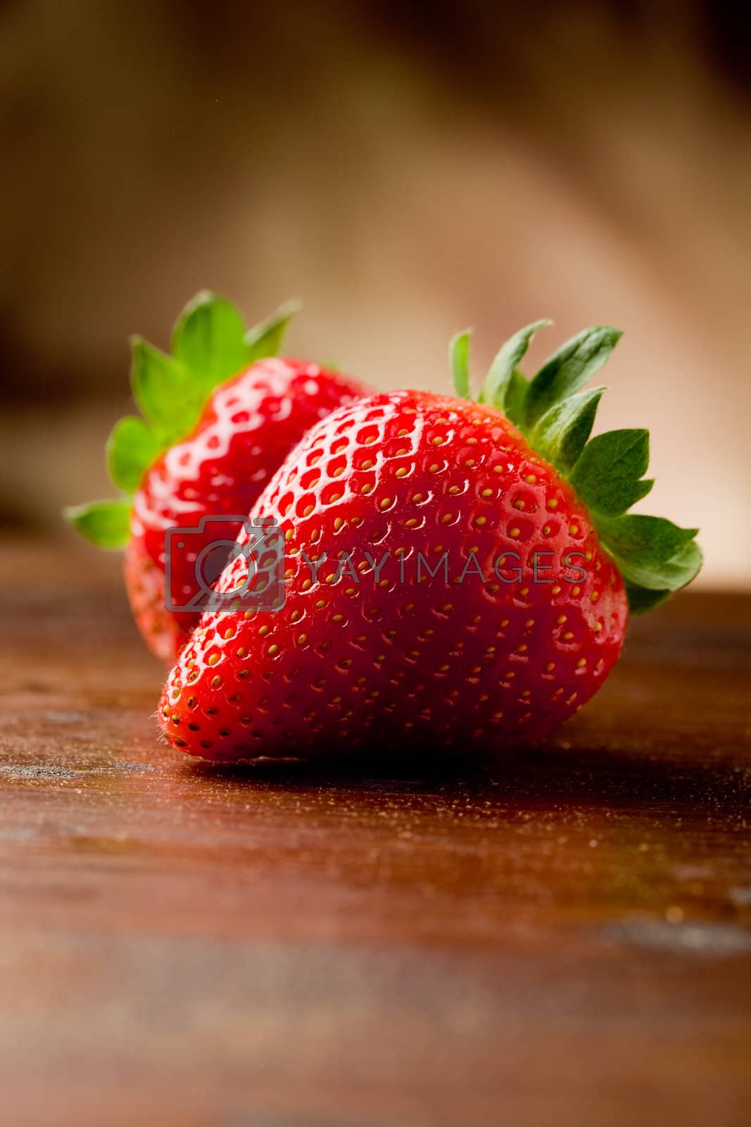 Royalty free image of Strawberries on wooden table by genious2000de