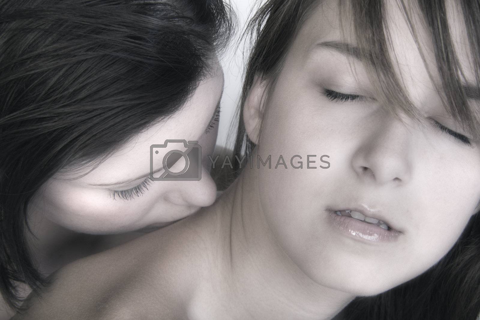 Royalty free image of females kissing by DNFStyle