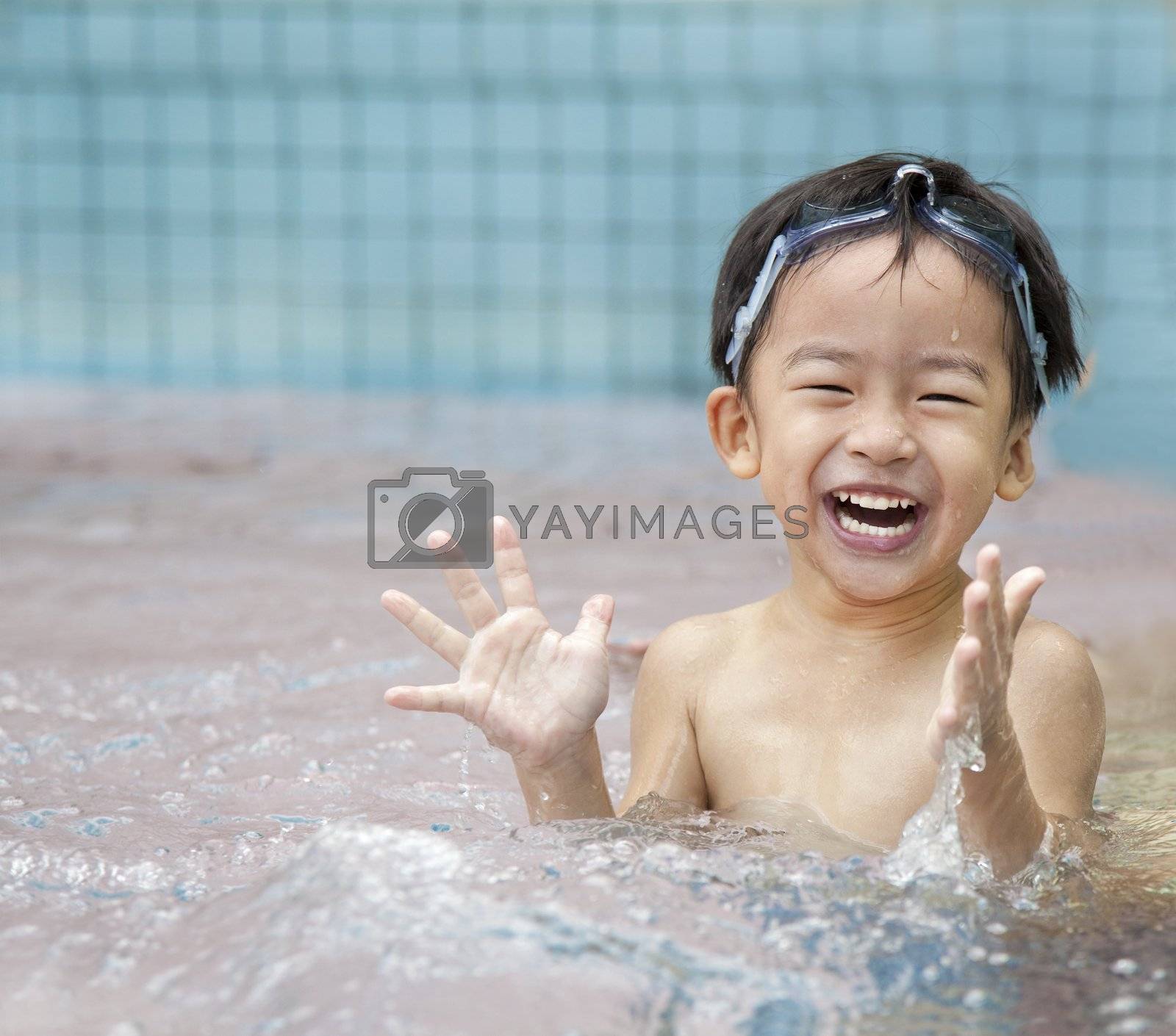 Royalty free image of happy kid in the water by tomwang