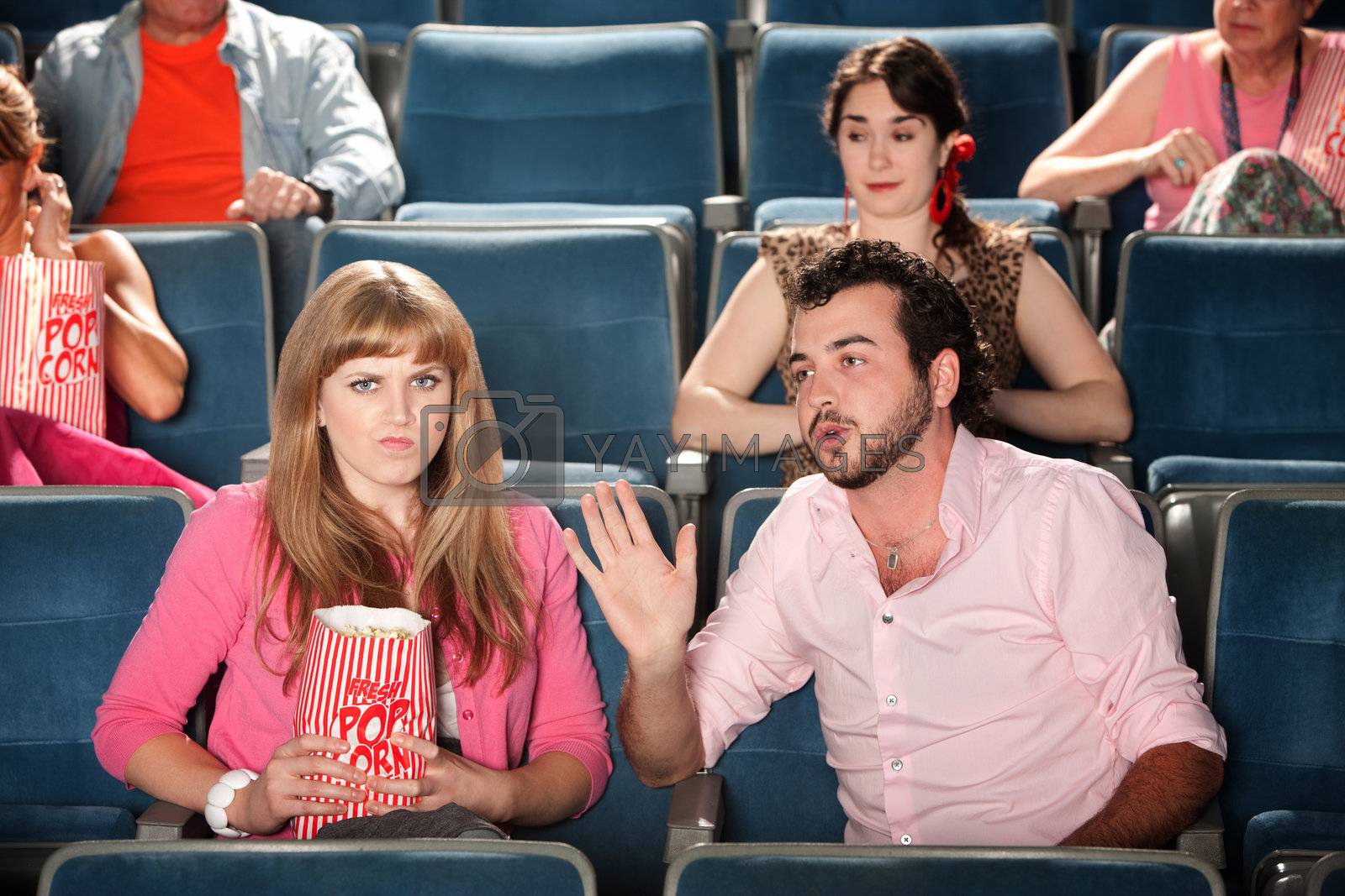 Royalty free image of Man Talks to Woman in Theater by Creatista