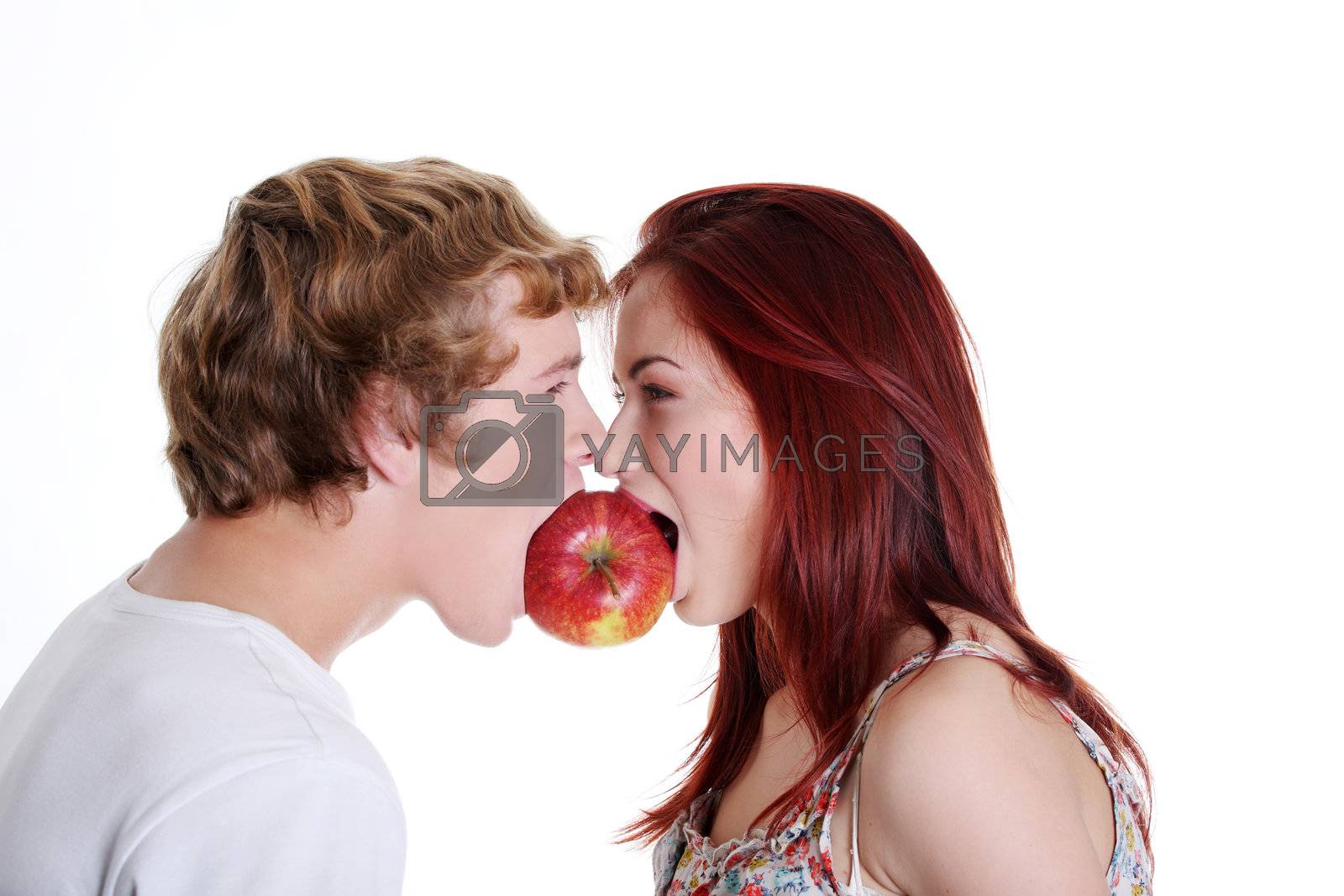 Royalty free image of Couple biting one apple. by BDS