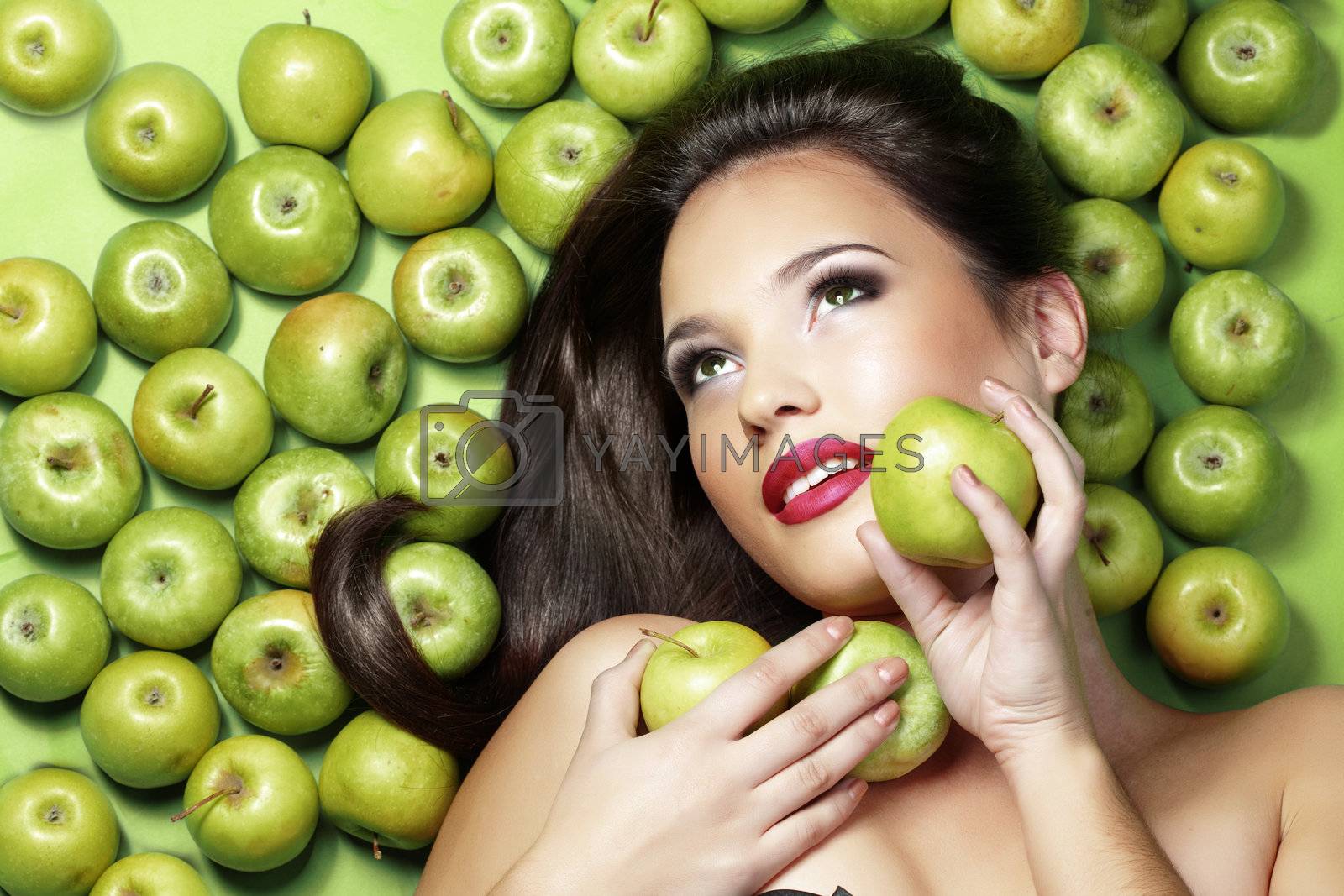 Portrait of young beautiful woman with apples