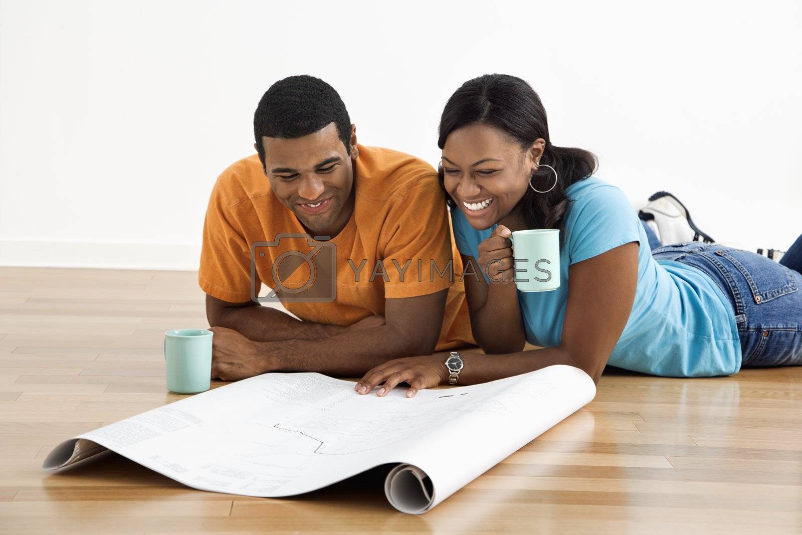 Royalty free image of Couple with blueprints. by iofoto