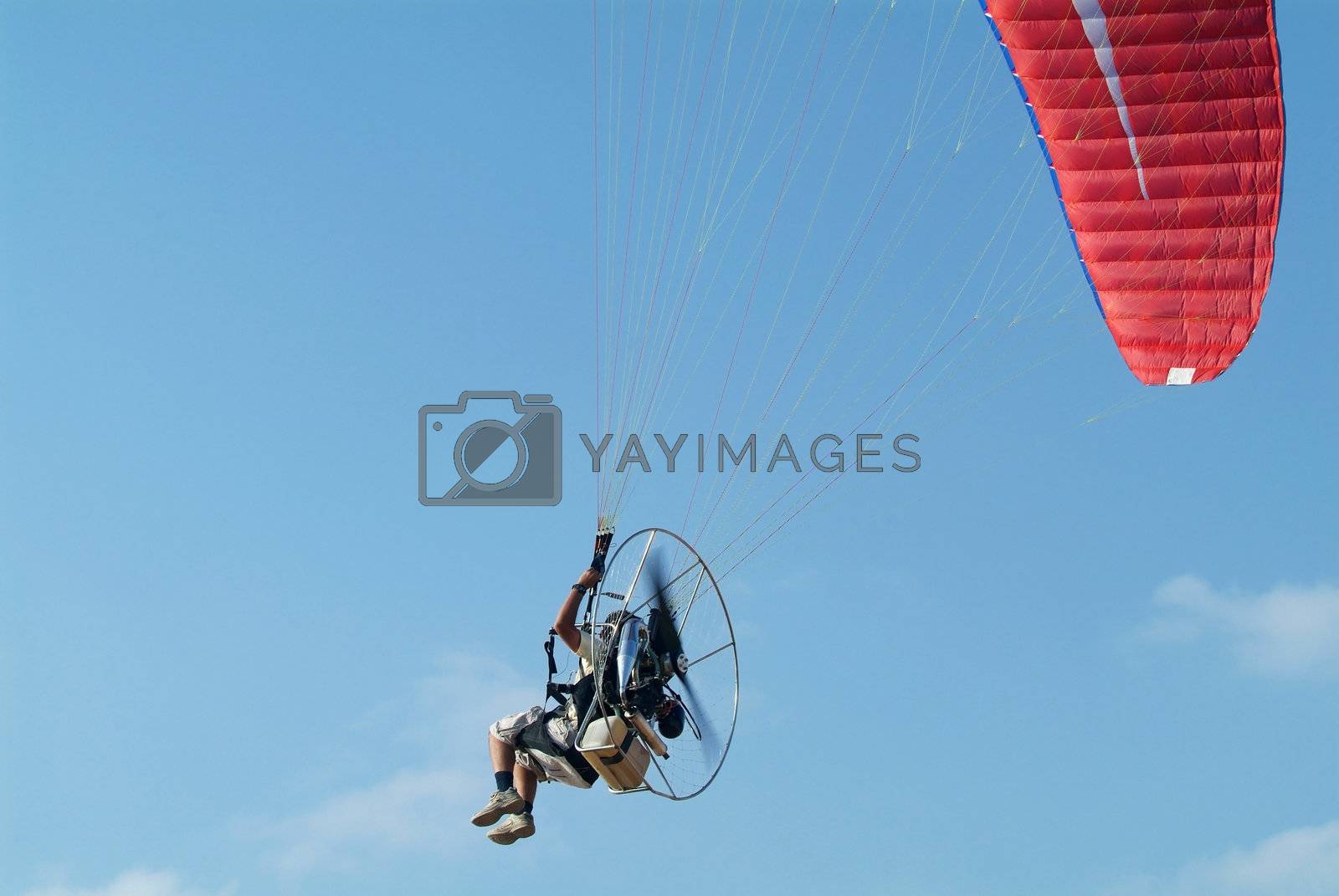 Royalty free image of Paramotor flying by epixx