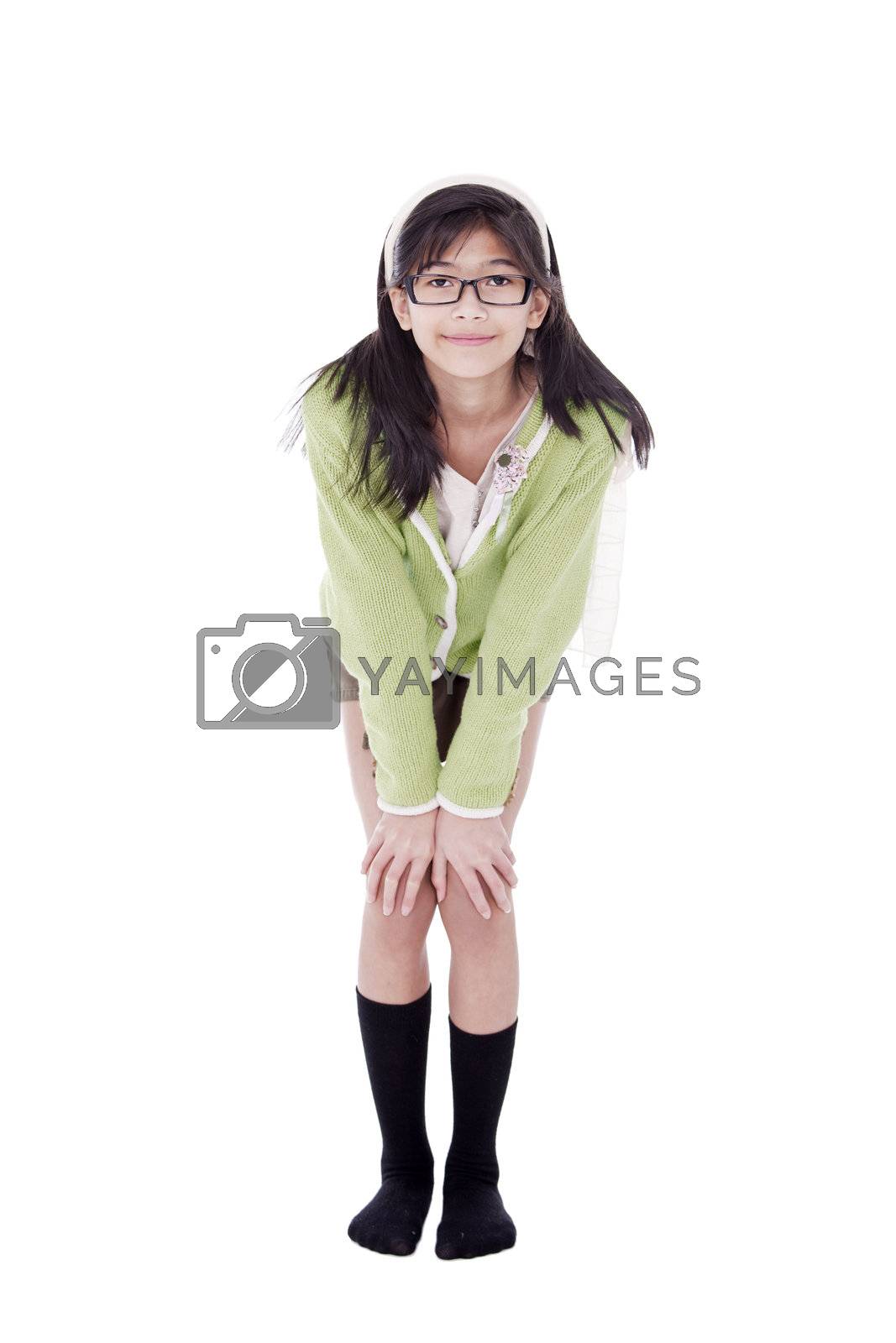Royalty free image of Girl in green sweater and glasses bending forward, hand on knees by jarenwicklund