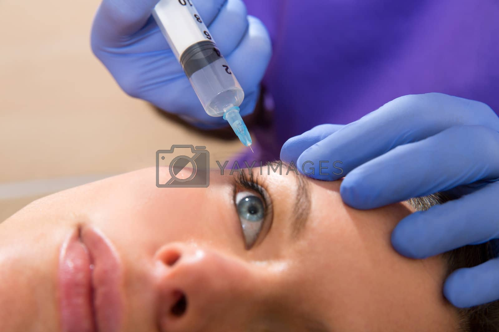 Royalty free image of Anti aging facial mesotherapy syringe on woman face by lunamarina