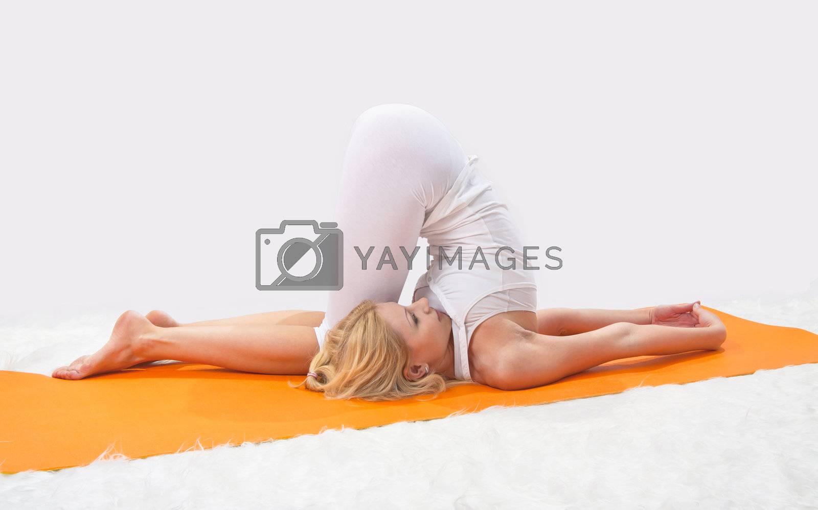 Royalty free image of Young beautiful girl is professionally engaged in yoga  by NickNick