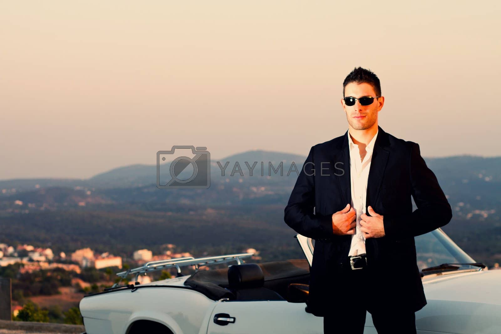 Royalty free image of man with white convertible by membio