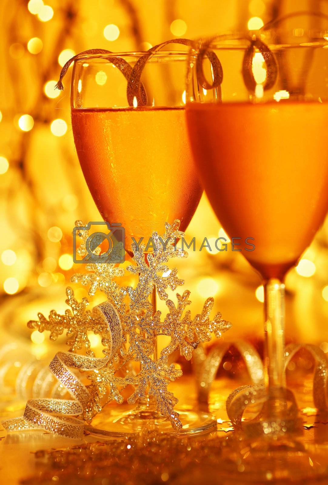 Romantic holiday drink, celebration of Christmas or new year eve, party with Champagne and festive gold ornament lights decoration