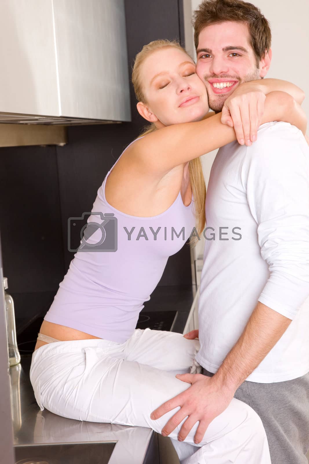 Royalty free image of couple at home embracing by ambro