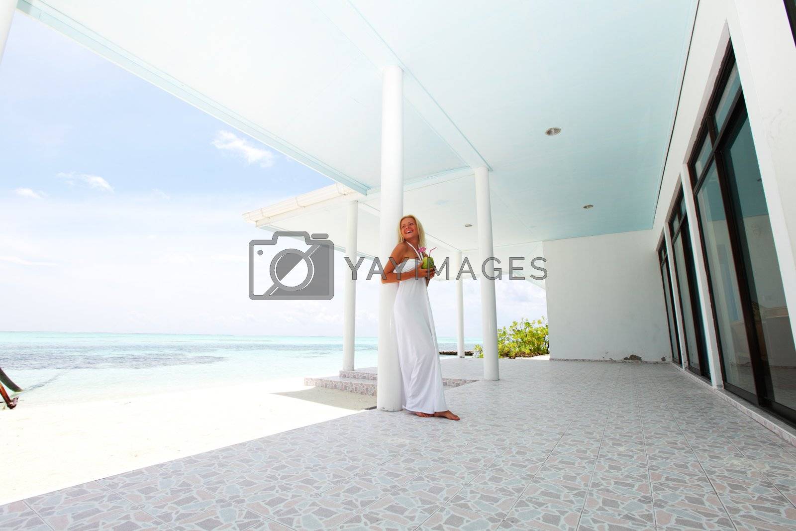Royalty free image of tropic woman on the veranda by Yellowj