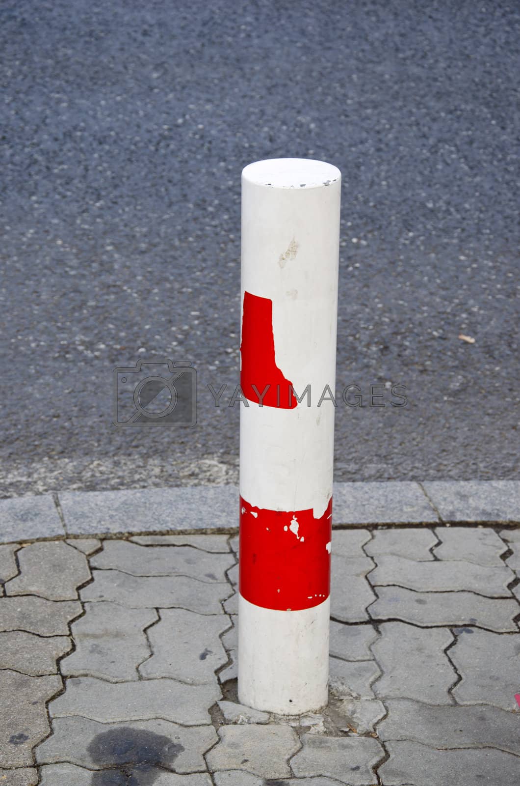 Royalty free image of column prevents car to pass road prohibited area. by sauletas