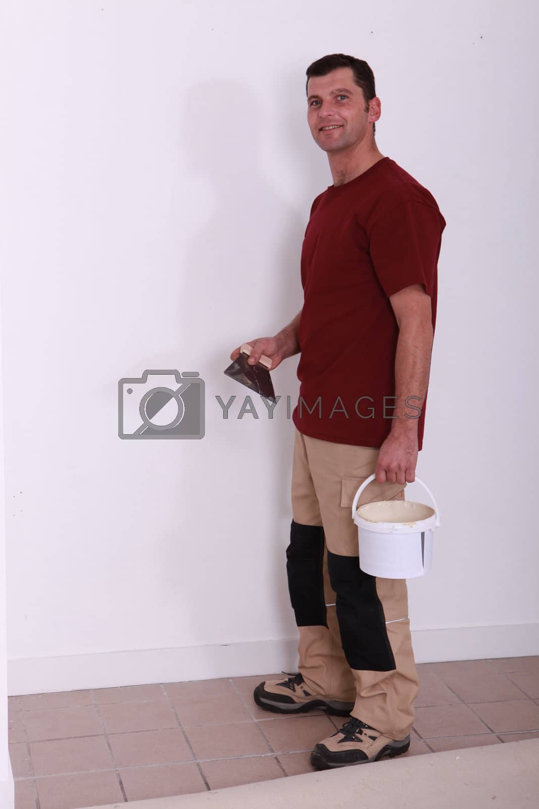 Royalty free image of handyman with a glue pot and a float by phovoir