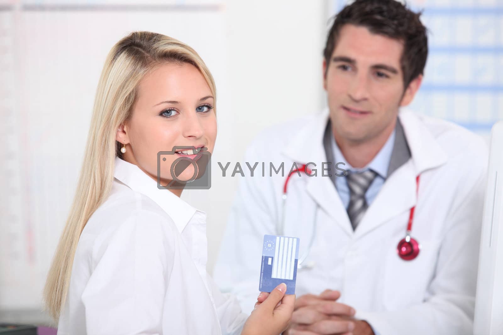 Royalty free image of Young female patient registering her details by phovoir