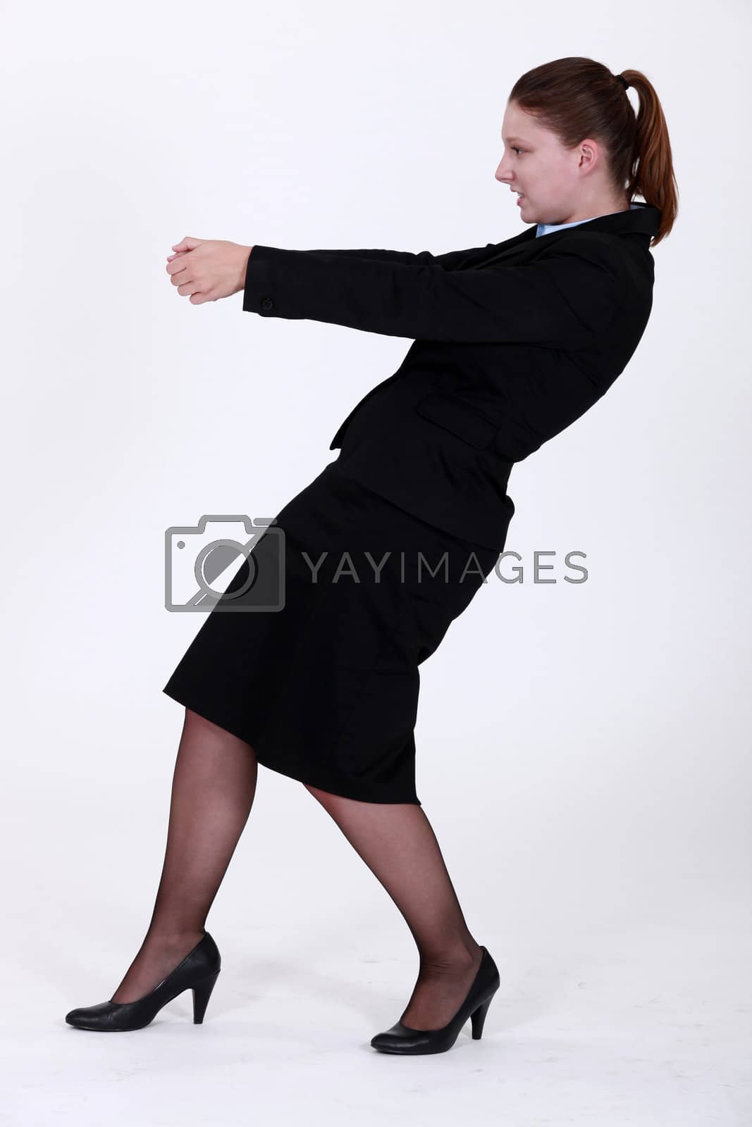 Royalty free image of Businesswoman pulling an invisible object by phovoir
