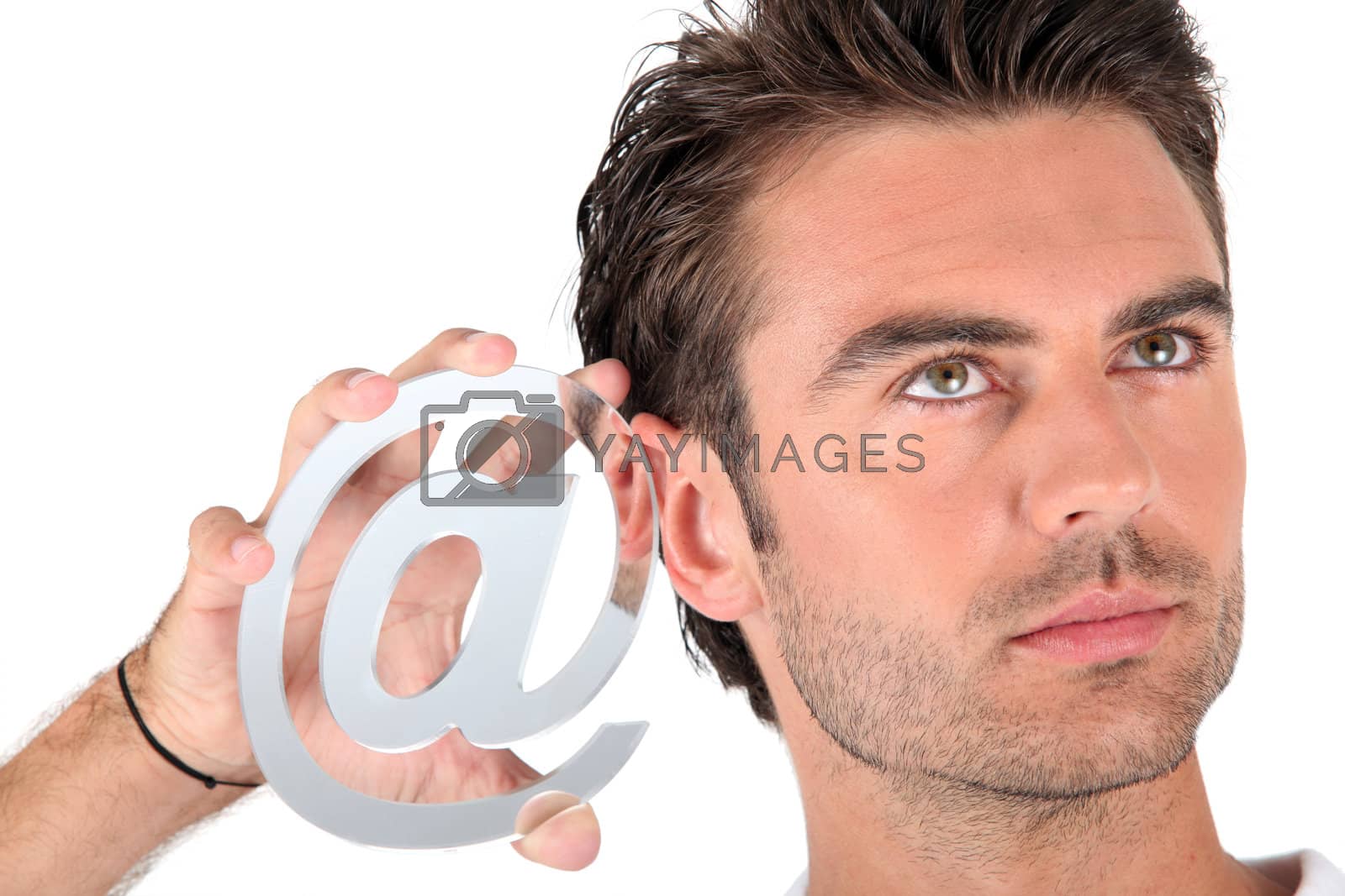 Royalty free image of Man holding an @ sign by phovoir