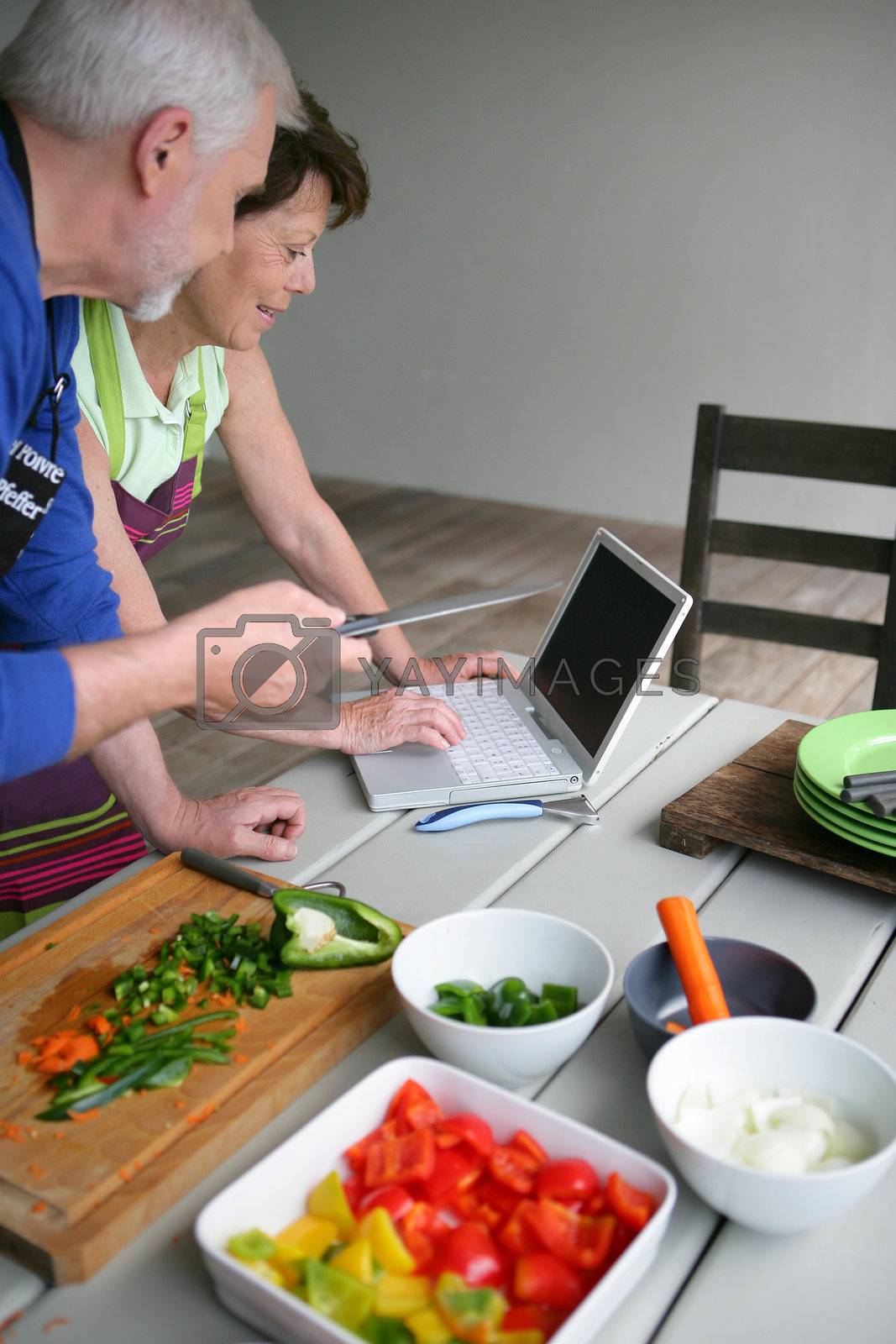 Royalty free image of Couple looking at a recipe on-line by phovoir