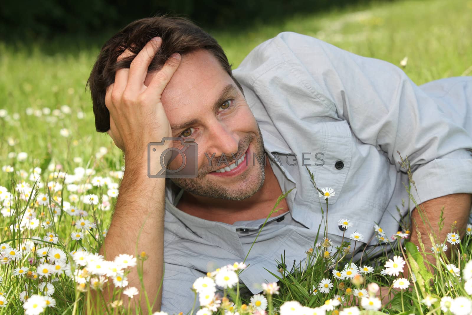 Royalty free image of Man lying on grass by phovoir