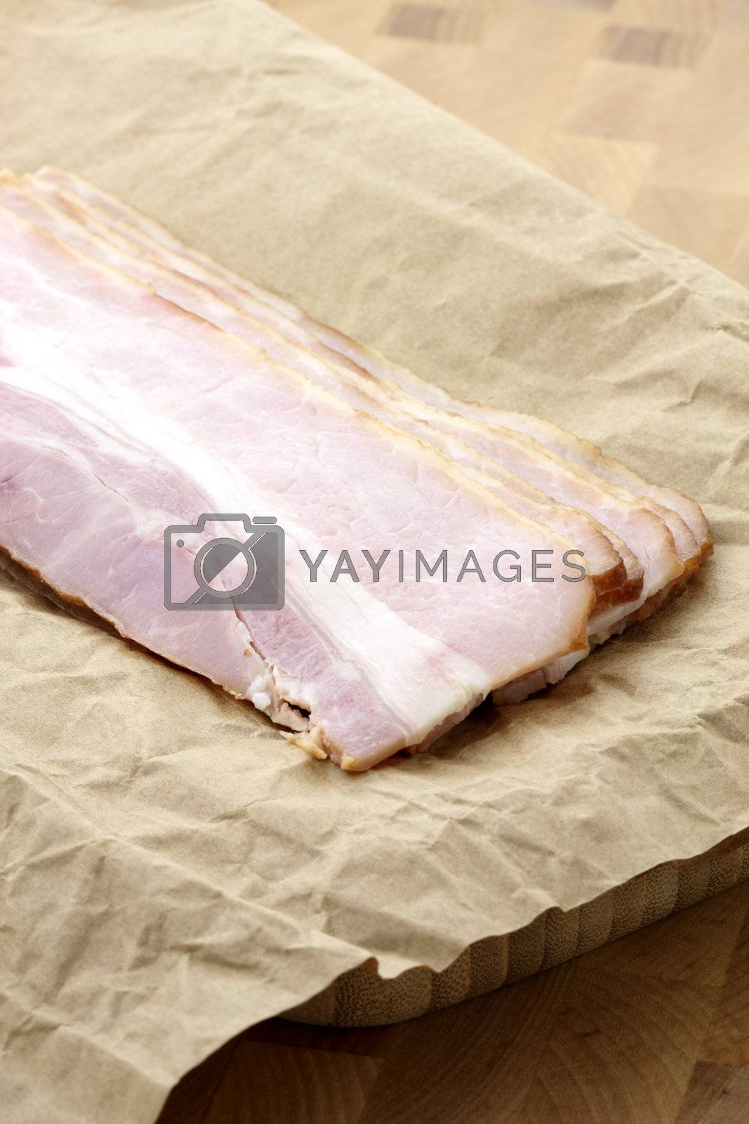 Royalty free image of cured delicious bacon by tacar