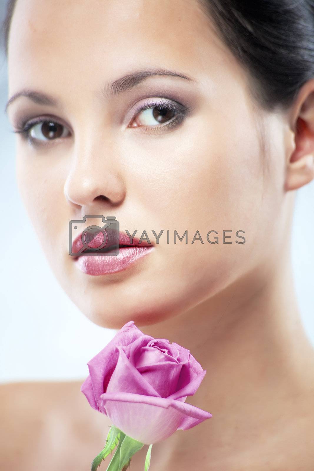 Studio portrait of sensual beautiful woman with rose