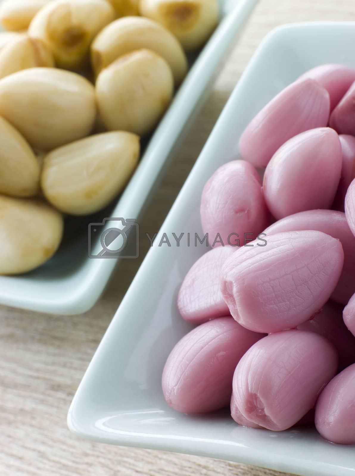 Royalty free image of Dishes of Pickled Garlic by MonkeyBusiness