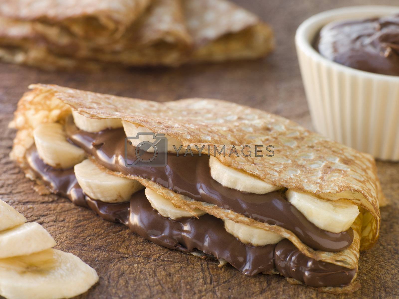 Royalty free image of Crepes filled with Banana and Chocolate Hazelnut Spread by MonkeyBusiness